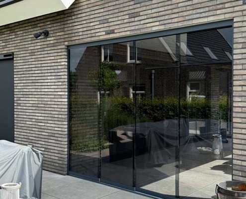 glazen-schuifwand-donker-glas-heesch Glazen schuifwand met donker getint glas 10mm op modern terras Heesch voor windscherming en privacy